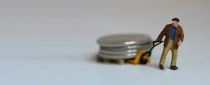 This man needs more training in the proper handling of coins.  Never drag a coin along a surface because it could easily damage the coin. This man needs more training in the proper handling of coins.  Never drag a coin along a surface because it could easily damage the coin.